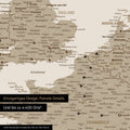 Europe map in desert sand as canvas for pinning shows a section of England, France, and Belgium with many details such as national parks, rivers, and numerous small towns and cities, some of which are marked with pins