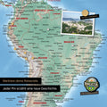 Detail of a magnetic physical world map as a magnetic board in multicolor terra showing South America with a pinned photo as well as travel and vacation magnets
