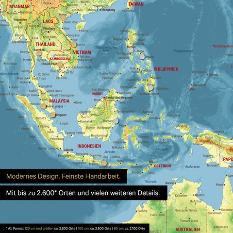 Section of a magnetic topographic world map in multicolor topo showing a map of Asia, with magnets marking travel destinations