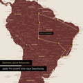 Detail of a world map as a Push Pin Map in Bordeaux red showing a section of South America, where pins mark visited travel destinations and are connected with a colorful thread
