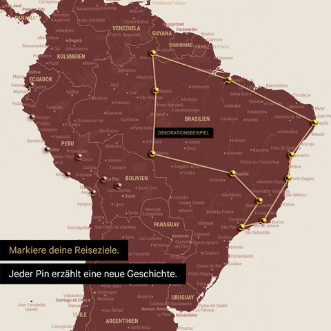 Detail of a world map as a Push Pin Map in Bordeaux red showing a section of South America, where pins mark visited travel destinations and are connected with a colorful thread