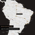 Detail of a world map as a Push Pin Map in black and white showing a section of South America, where pins mark visited travel destinations connected by a colorful thread