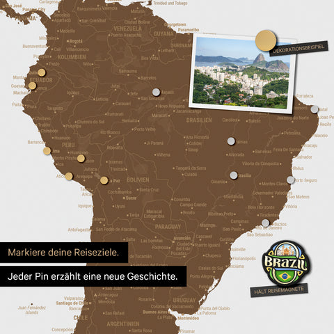 Detail of a magnetic world map as a brown magnetic board showing South America with a pinned photo as well as travel and vacation magnets