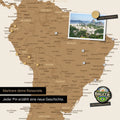 Detail of a magnetic world map as a bronze magnetic board showing South America with a pinned photo as well as travel and vacation magnets