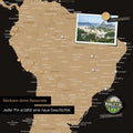 Detail of a magnetic world map as a magnetic board in Multicolor Sonar Black (Black-Gold) showing South America with a pinned photo as well as travel and vacation magnets