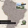 Detail of a magnetic world map as a magnetic board in warm gray (brown-gray) showing South America with a pinned photo as well as travel and vacation magnets